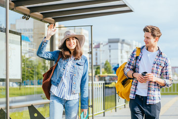 People student traveling concept. Couple traveling together standing at bus station, Waiting for transport. High Resolution