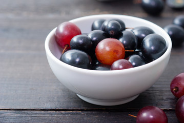red grapes on black wood table