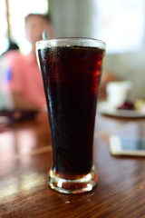 Black coffee, reception table, relaxation with food and drinks, focus on the glass and blur the background