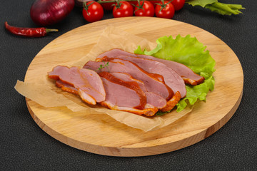 Sliced smoked duck breast served salad