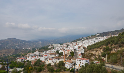 Fototapeta na wymiar The traditional Spanish Mountain Village of Sayalonga in Andalucia with its many Villas and Houses seemingly tumbling down the Hills.