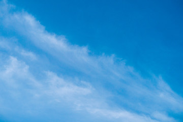 The blue sky with moving white clouds. The sky is a beautiful color shade suitable for use as a background image.