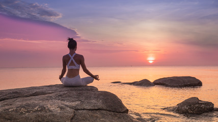 Asian girl practice Yoga on the beach Sunrise morning day