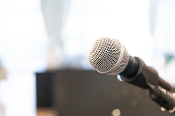 Microphone on abstract blurred of speech in  room or speaking conference Event Background