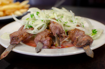 Beautiful shish kebab or shashlik on skewers served at small asian cafe