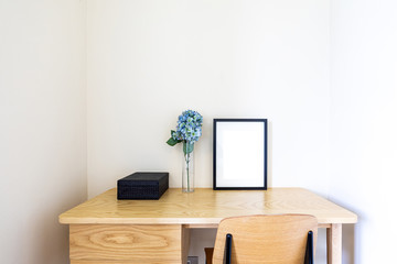 The mock up photo frame on wooden shelf  Concept of minimalist shelfie.