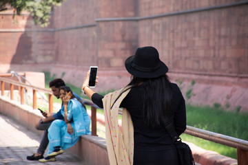 Indian women journey visit and travel for take photo with Red Fort or Lal Qila of World Heritage Site at the ancient city of Delhi in New Delhi, India
