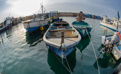 Fishing boats at old Jaffa port. Fisheye photo - obrazy, fototapety, plakaty