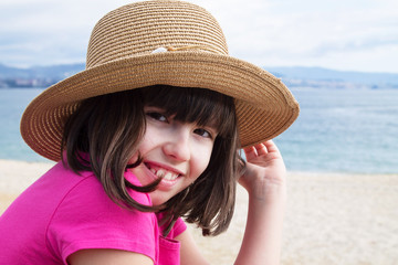 portrait of girl with hat on the beach