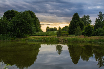 Fototapeta na wymiar Summer pond at summer sunset