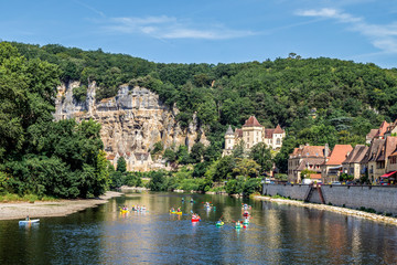 Fototapeta na wymiar La Roque Gageac, one of France's most beautiful villages by the Dordogne River, backed by a steep hill / cliff, Malartrie Castle in the background. Travel France.