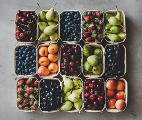 Keuken spatwand met foto Summer fruit and berry variety. Flat-lay of strawberries, cherries, grapes, blueberries, pears, apricots, figs in wooden eco-friendly boxes over grey background, top view. Local farmers produce © sonyakamoz