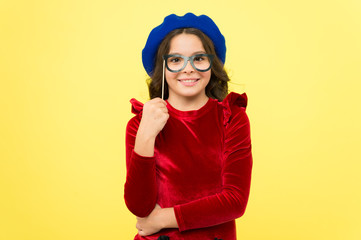 Accessory for celebration. Happy little child glasses props. Funny small girl holding glasses photo booth props on stick. Cute kid with fancy party props. Party decorations supplier. Party shop