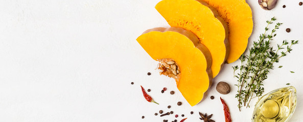 Slices of ripe pumpkin with spices and olive oil. Autumn food concept. Banner for site - Powered by Adobe