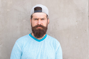 Hipster lifestyle. Cool hipster with beard wear stylish baseball cap. Brutal handsome mature hipster man. Bearded man trendy style. Barber salon and facial hair care. Beard and mustache grooming