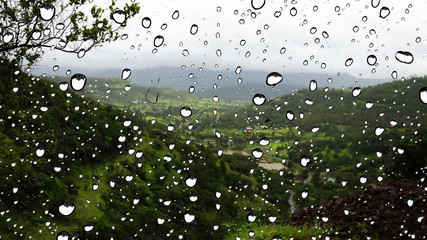 Mountain view from Glass window during rain