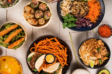 Asian food background with various ingredients on rustic wooden table.