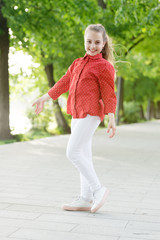 Fototapeta premium Always fashionable. Happy little child in fashionable wear on summer day. Adorable fashionable girl smiling on fresh air. Fashionable look of small vogue model
