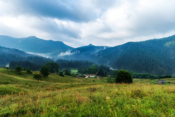 Fototapeta na wymiar Foggy morning over Chairski lakes chalet in Rhodope mountain, Bulgaria