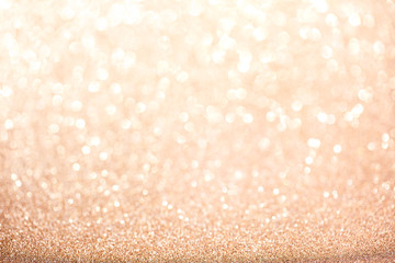 Gold blurred glitter background. Sparkling and shiny texture for Christmas and New Year holiday or...