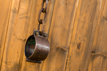 old metal shackles closed chain ring wooden wall background