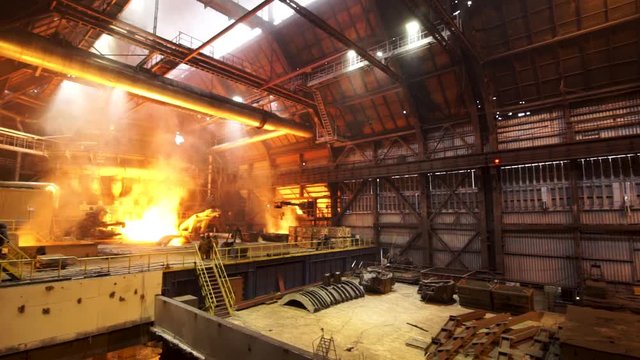 Panoramic view of the constructions inside the manufacturing metallurgical plant, heavy industry concept. Stock footage. Hot shop at the factory.