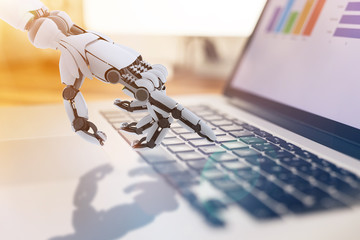 Robotic hand working with notebook. Conceptual technology design.