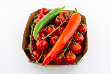 square basket set of red cherry tomatoes long peppers peppers spicy green on white background