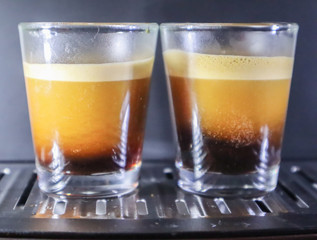 Close-up of espresso pouring from coffee machine. Professional coffee brewing