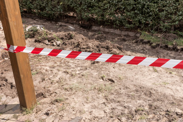 Barrier red and white tape. Construction site shutdown due to risk of injury