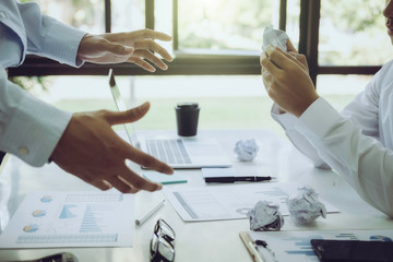 Asian business people meeting with new startup project pointing graph discussion and analysis data charts and graphs.Business finances and accounting concept