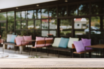 Empty wooden table blurred of restaurant cafe background and reception room, can be used for display or montage your products