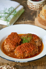 Meat cutlets with cabbage in tomato sauce