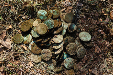 Real treasure with copper coins in the forest. Discovery, treasure hunting, digging, metal...