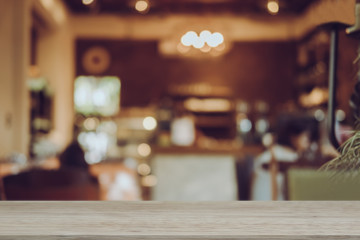 Empty wooden table blurred of restaurant cafe background and reception room, can be used for display or montage your products
