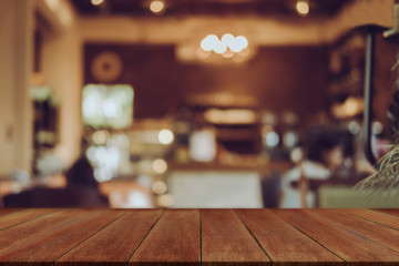 Empty wooden table blurred of restaurant cafe background and reception room, can be used for display or montage your products