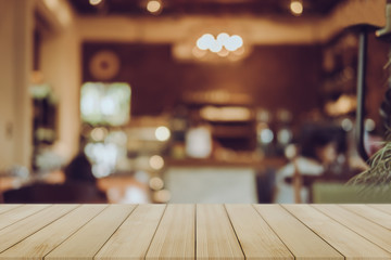Empty wooden table blurred of restaurant cafe background and reception room, can be used for display or montage your products