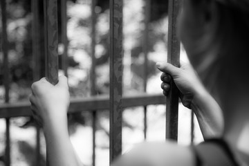 Prison cell: Close up of hands in jail