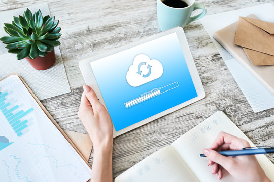 Cloud synchronization progress bar on tablet screen. Data storage and protection. Technology and internet concept.