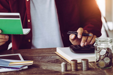 asian man working with calculator to calculate numbers. expenses calculator, payments costs with paper notes, payments table. Financial and Installment payment concept. Saving concept - Image