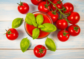 Fresh tomato juice as a source of vitamins. Wooden background.