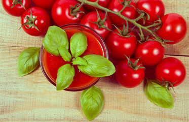 Fresh tomato juice as a source of vitamins. Wooden background.