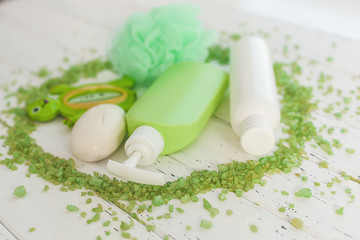 Bathing accessories. Green tubes and bottles for bath. Shower stuff. SPA for kids.