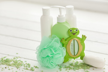 Bathing accessories. Green tubes and bottles for bath. Shower stuff. SPA for kids.