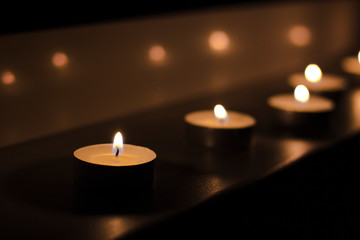  burning candles on a black background