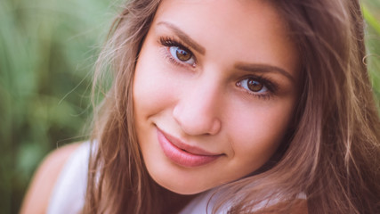 Fototapeta premium Close-up of charming beautiful young girl looking at the camera.