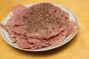 dinner source of protein slice of pork steak seasoned on a wooden table close-up