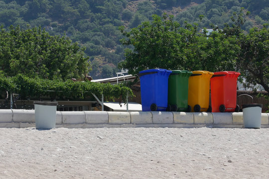 Plastic tanks for separate collection of garbage. Beach in Oludeniz.