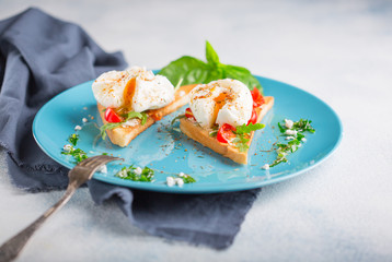 Poached eggs and toasted toast on a blue plate