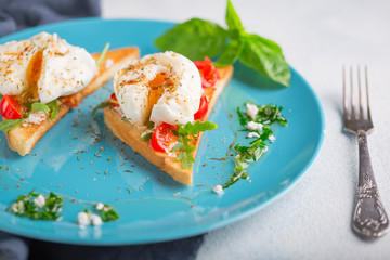 Poached eggs and toasted toast on a blue plate